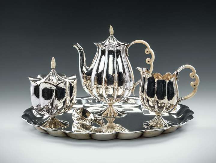 MUSEUM-QUALITY SILVER TEA SET
consisting of: teapot, creamer, covered sugar bowl, sugar tong, tray


